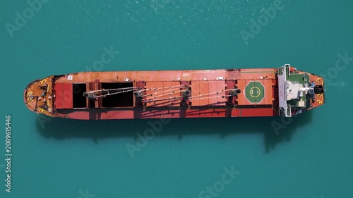 Top Down Aerial View of Cargo Ship in Turquoise Sea
