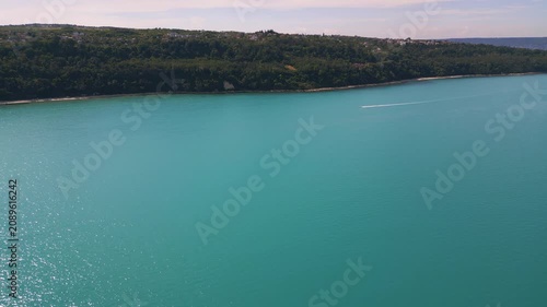 Aerial View of Turquoise Sea, Sandy Beach and Green Forest Coastline