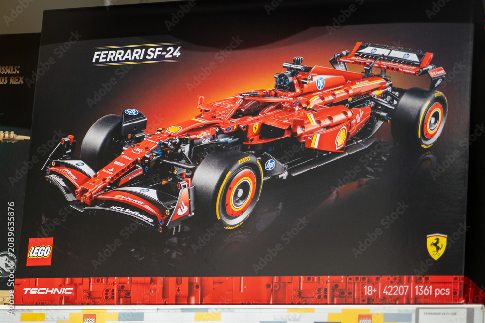 Obraz premium Lego Technic Box on a Shelf Featuring a Red Ferrari SF-24 Formula One Racing Car Model Construction. Milan, Italy - June 24, 2026