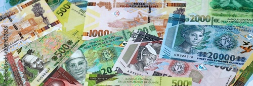 Cuadro en lienzo Guinean franc money banknotes bunch on table