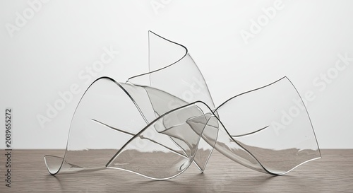 Modern abstract glass sculpture on table.