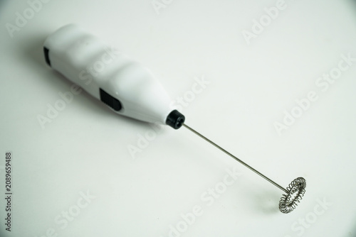 White Handheld Battery Operated Milk Frother with Whisk on a Clean Background
