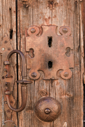 Obraz na plátně Vintage wooden door with wrought iron details
