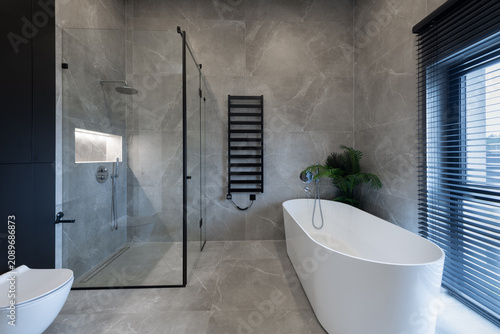 Modern Minimalist Bathroom With Freestanding Bathtub, Glass Shower and Gray Marble Tiles