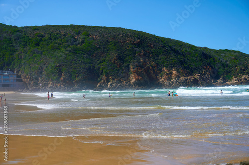 Photography People swimming and surfing at beach near green hill