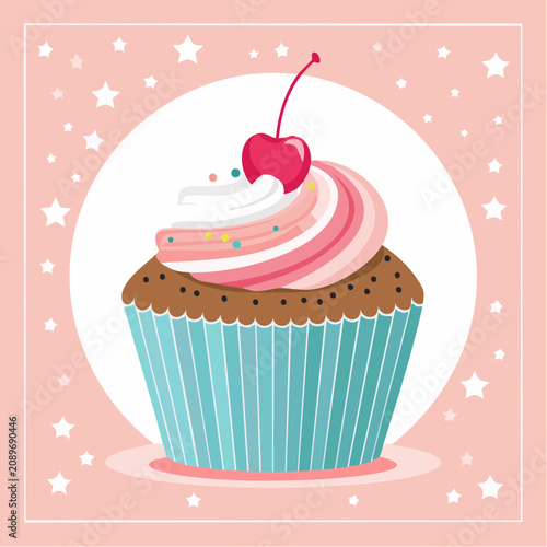A colorful cupcake with swirled frosting and a cherry on top sits in a decorative wrapper.