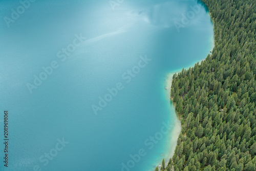 Aerial View of Cuopu Lake Sapphire Blue Water and Primeval Pine Forests in Batang, Western Sichuan