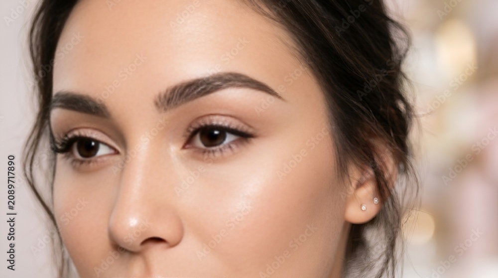 Fototapeta premium Close-up portrait of a beautiful young woman with flawless skin and perfect eyebrows.