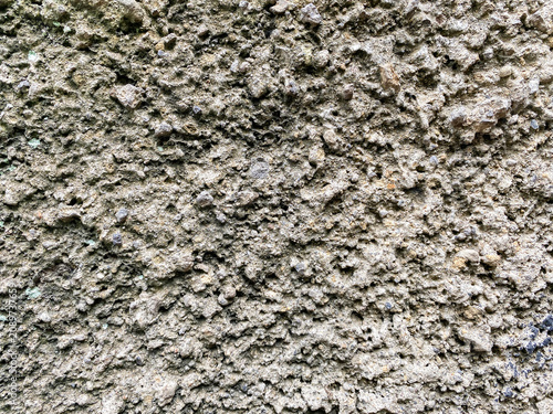 Konstfotografi A close up view of a coarse and gritty concrete wall surface with a natural gray stone texture
