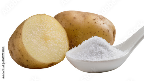Isolated fresh whole and half raw potato with a white spoon full of fine crystal salt