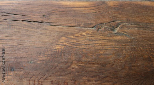 Vászonkép A close-up of the texture of an old dark brown wooden board coated with clear varnish