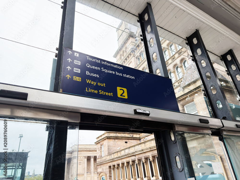 Obraz premium Lime Street station interior with directional signage, glass canopy and tourist information at Liverpool, UK