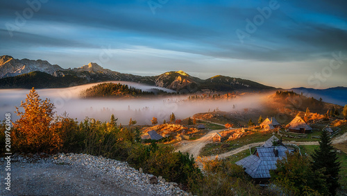 Konstfotografi Velika Planina plateau in Slovenia at sunset with fog