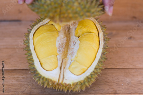 the man open peel of Long Lablae Durian type on the plate 