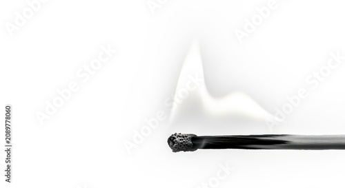 A burnt matchstick with smoke gently rising, set against a clean white background.