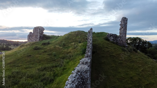 Tableau sur toile Aerial view showing the weathered stone remains of Harbottle Castle walls