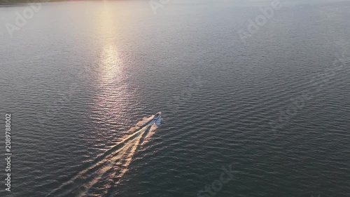 Wide Angle Drone View of Speeding Boat on Lake Maggiore at Sunset