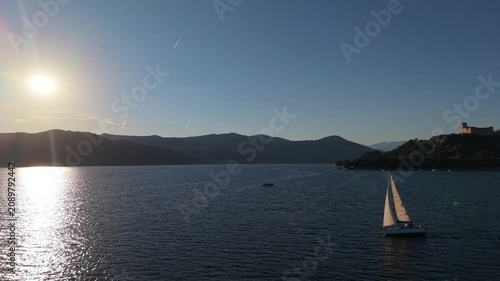 Aerial Sunset View of a Lone Sailboat on Calm Lake Water