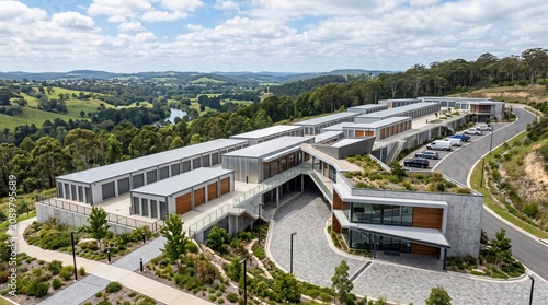 Modern Storage Facility Architecture: An aerial view showcases a contemporary self-storage facility with a modular design, integrated with the surrounding natural landscape and rolling hills.