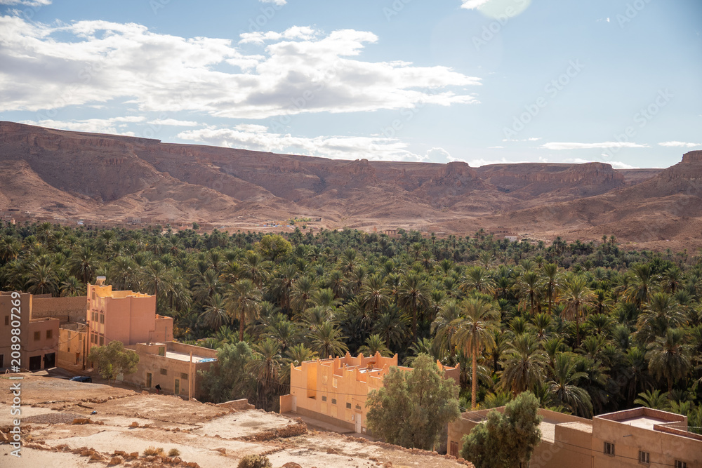 Obraz premium Small village in a valley with an oasis, on the highway to Merzouga, Morocco