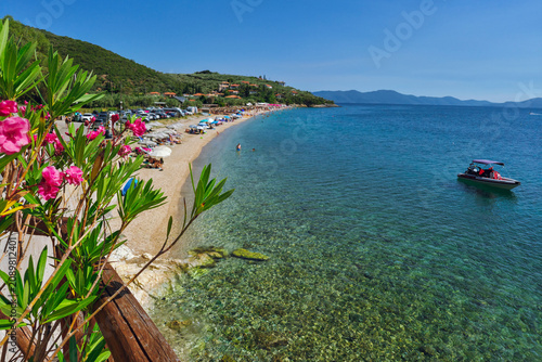 Panoramic view with flowers to Ampovos beach(Paralia Ampovos) with blue turquoise waters in Afissos, Pelion, Greece