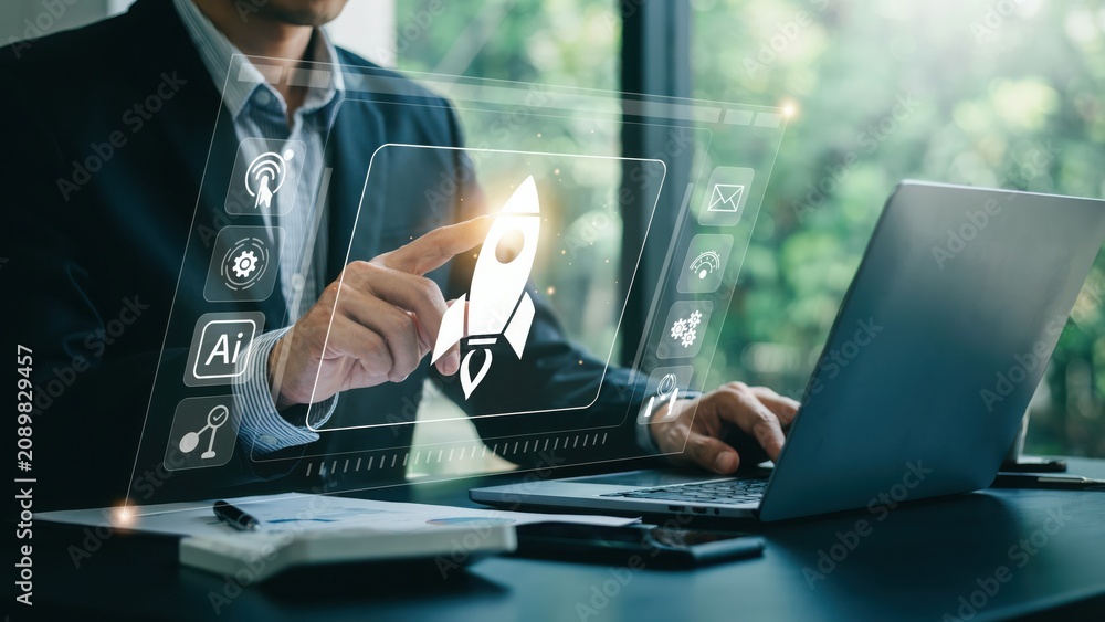 Fototapeta premium Businessman using digital tablet with creative software icons in a modern office