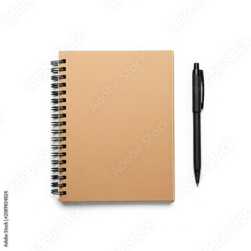Tan spiral notebook and black pen for writing notes