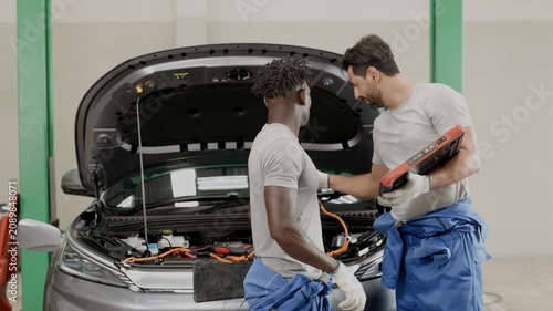 Profession EV Car auto service, Monitor checkup battery balancing in Electric vehicle garage auto workshop