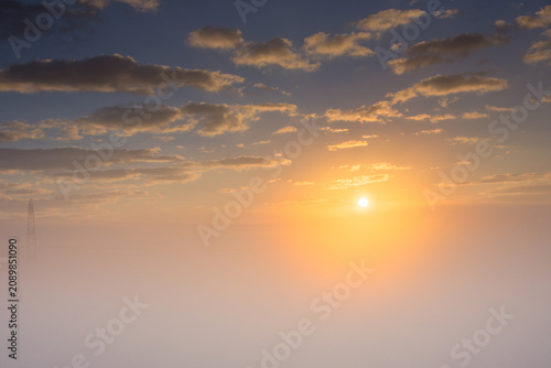 Obraz na plátně Sunrise Over Fog Sea With Clouds and Distant Power Tower