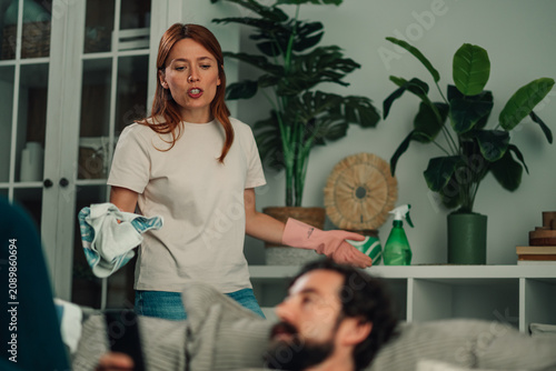 Canvas Print Frustrated woman arguing with lazy man, expressing discontent about relationship