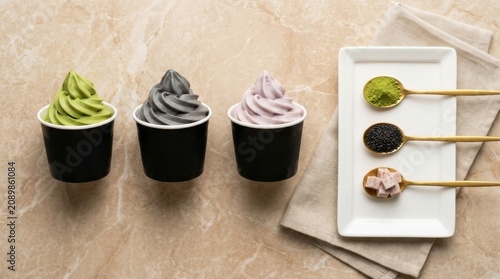 Tempting assortment of soft serve ice cream flavors topped with various delicious ingredients on a simple backdrop