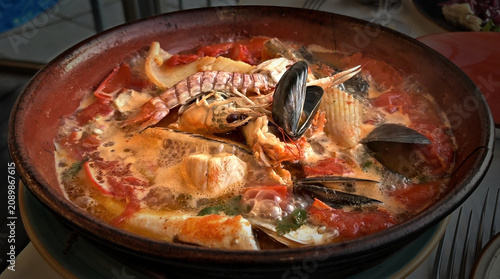 view of a steaming and appetizing plate of tomato fish soup