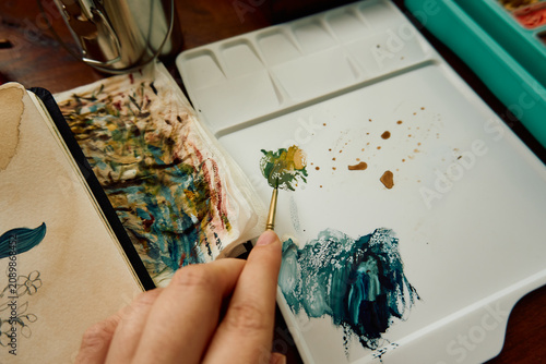 Artist checking the appropriate paints
