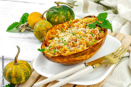 Baked spaghetti squash with spices, herbs and tomato sauce. Gluten free food, healthy dinner, vegan