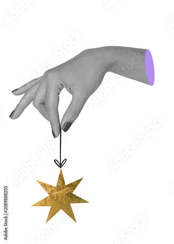 Hand holding golden Christmas star ornament. Festive mixed media collage. New year decoration element.
