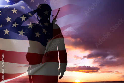 Obraz na plátně Silhouette of a soldier with USA flag against the sunset
