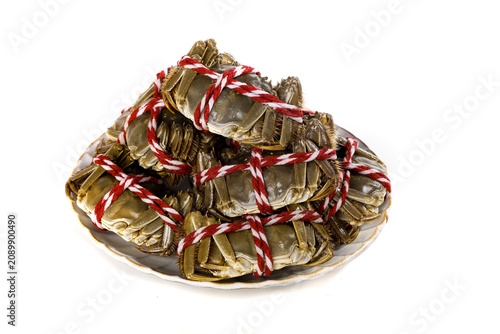 Fresh Hairy Crabs Tied with Red Rope on Plate - Traditional Asian Seafood Delicacy Ready for Steaming