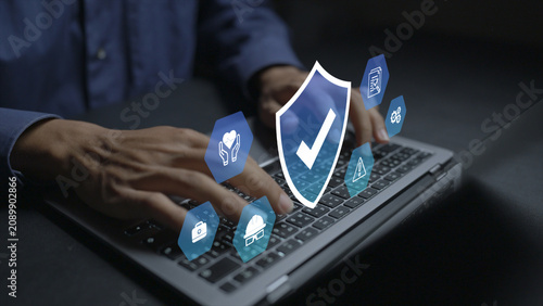 Work safety concept. Person using laptop with workplace safety and compliance icons, occupational health, risk prevention and employee protection.