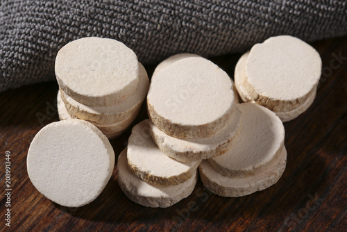Fresh Chinese Yam Slices Arranged on Wood Surface - Traditional Herbal Medicine Ingredient Studio Shot
