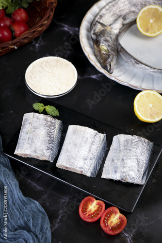 Fresh Frozen Fish Segments with Lemon and Vegetables Studio Food Photography