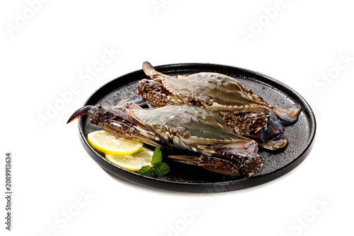 Fresh Raw Crabs on Black Plate with Lemon Garnish Studio Food Photography