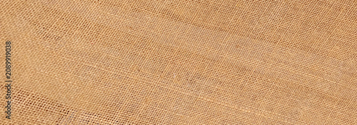 Tableau sur toile Hessian sackcloth burlap woven texture background, Cotton woven fabric close up with flecks of varying colors of beige and brown, with copy space for text decoration