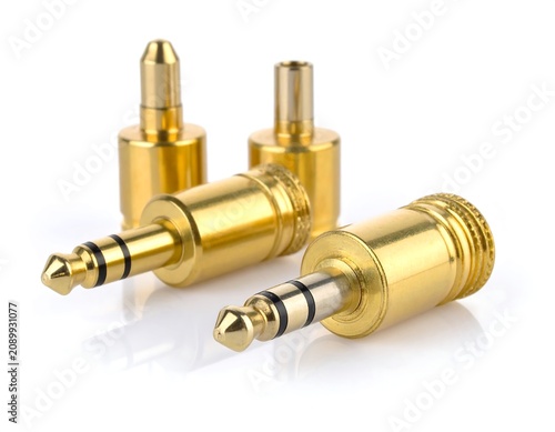 Three gold-plated audio connectors on a white background