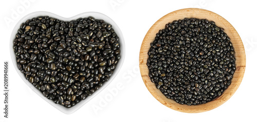 Картината върху платно Black bean or Urad dal, black gram, vigna mungo in ceramic and wooden bowl isolated on the white background