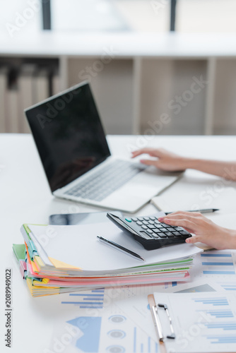 Auditor and accountant team working in office, analyze financial data and accounting record with calculator. Accounting company provide finance and taxation planning for profitable cash flow. Insight	