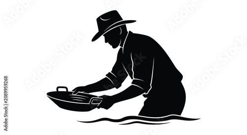 Cuadro en lienzo Gold panner with pan in water a black silhouette against a white background silh