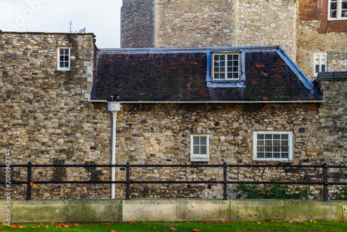 Photography Ancient medieval stone walls and historic cottage at the Tower of London