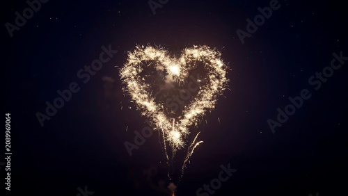 Sparklers forming a heart shape in the dark night air