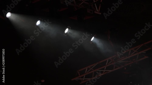 Spotlights in the concert hall. Stage light with colored spotlights and smoke.