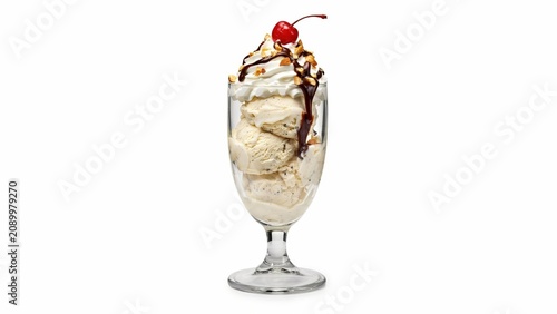 Delicious vanilla ice cream sundae served in a tall glass